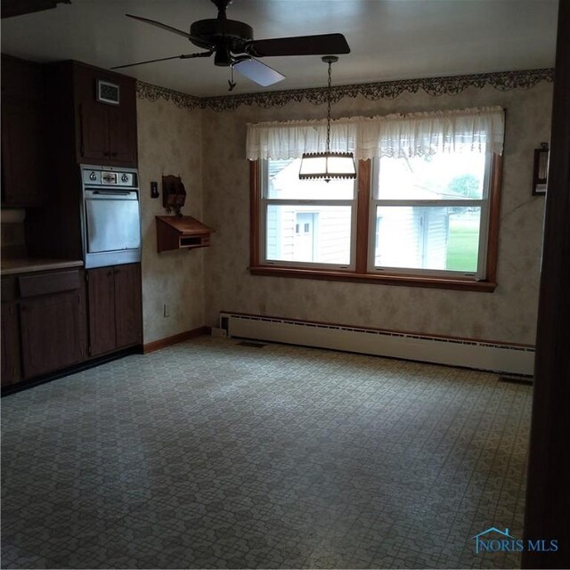 15979 Hill Rd, Defiance, OH 43512 - unfurnished dining area with a baseboard radiator, light colored carpet, a ceiling fan, and baseboards