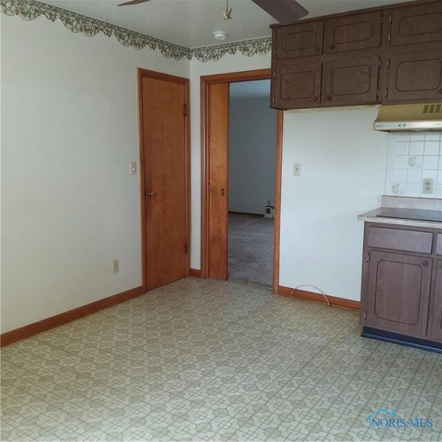 15979 Hill Rd, Defiance, OH 43512 - kitchen featuring under cabinet range hood, ceiling fan, light floors, and baseboards