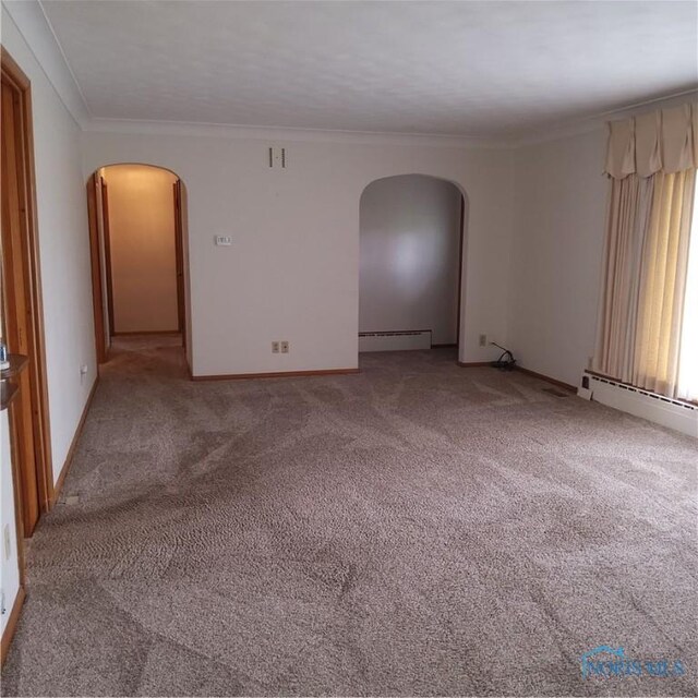 15979 Hill Rd, Defiance, OH 43512 - spare room featuring a baseboard heating unit, arched walkways, crown molding, light carpet, and baseboards