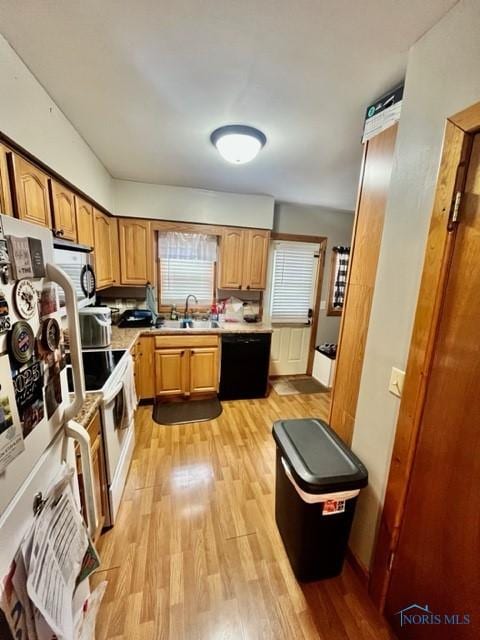 663 W Summit St, Fostoria, OH 44830 - kitchen with dishwasher, a sink, light countertops, and light wood-type flooring