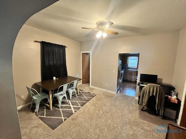 663 W Summit St, Fostoria, OH 44830 - carpeted dining room with a ceiling fan and baseboards