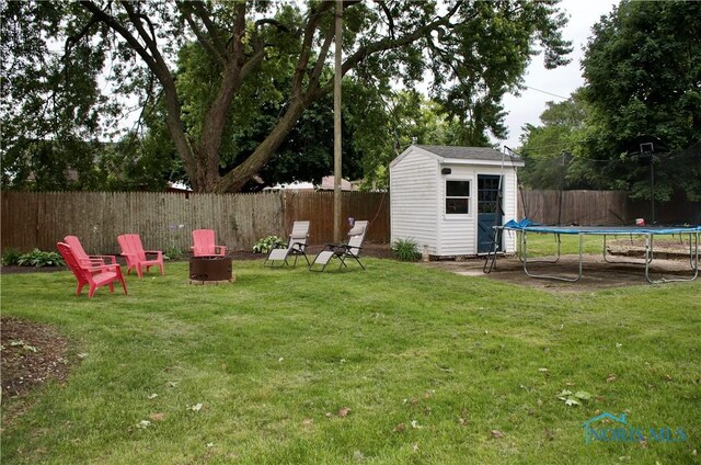 663 W Summit St, Fostoria, OH 44830 - view of yard featuring a trampoline and an outdoor fire pit