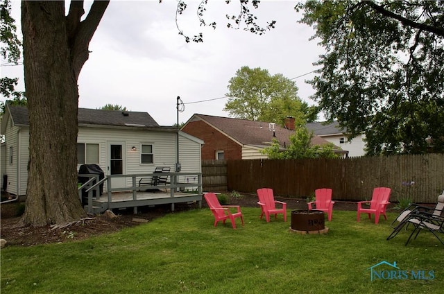 663 W Summit St, Fostoria, OH 44830 - view of yard featuring an outdoor fire pit and a wooden deck
