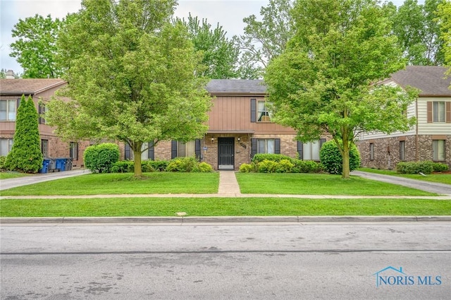 1701 Brownstone Blvd, Toledo, OH 43614 - view of property with brick siding and a front yard