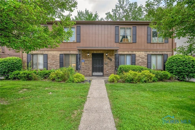 1701 Brownstone Blvd, Toledo, OH 43614 - view of property with a front lawn and brick siding