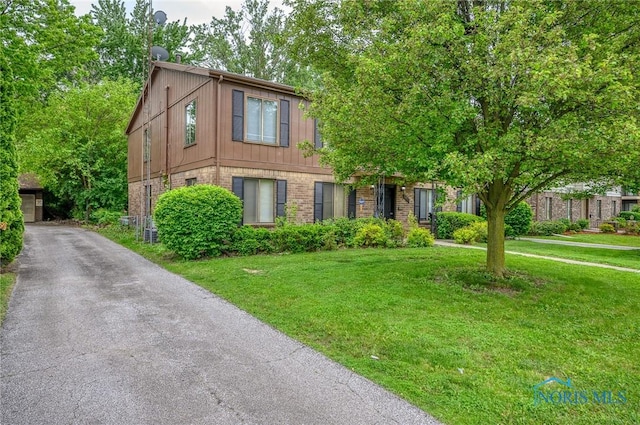 1701 Brownstone Blvd, Toledo, OH 43614 - view of front of house with brick siding and a front lawn