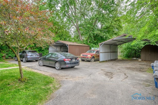 1701 Brownstone Blvd, Toledo, OH 43614 - view of parking with a shed, asphalt driveway, and a detached carport