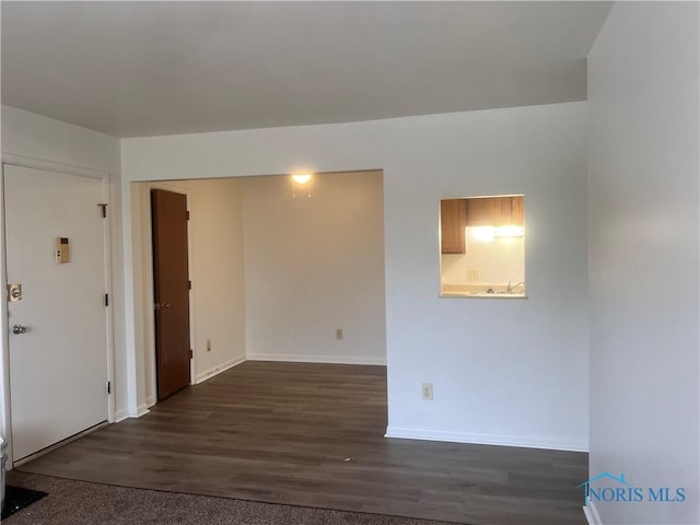 2134 Tedrow Rd, Toledo, OH 43614 - unfurnished room with baseboards and dark wood-type flooring