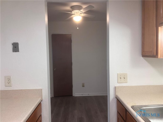 2134 Tedrow Rd, Toledo, OH 43614 - kitchen featuring ceiling fan, light countertops, dark wood-style floors, and brown cabinetry