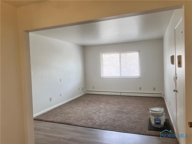 2134 Tedrow Rd, Toledo, OH 43614 - spare room with a baseboard heating unit, wood finished floors, baseboards, and carpet floors