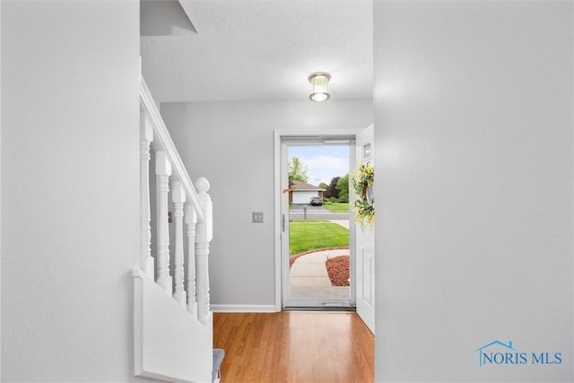 117 Freedom Ln, Waterville, OH 43566 - entryway featuring wood finished floors, a textured ceiling, and baseboards
