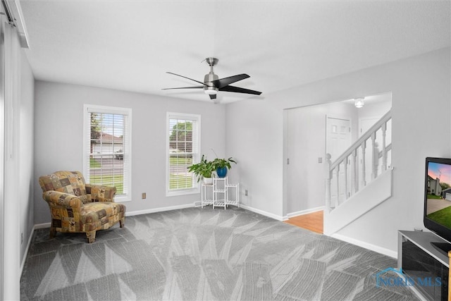 117 Freedom Ln, Waterville, OH 43566 - living area featuring carpet, baseboards, a ceiling fan, and stairs
