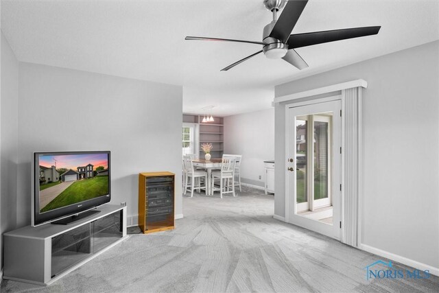 117 Freedom Ln, Waterville, OH 43566 - living area featuring carpet, a ceiling fan, baseboards, and a chandelier
