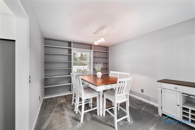 117 Freedom Ln, Waterville, OH 43566 - dining room with baseboards, dark colored carpet, and built in features
