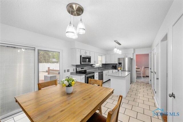 117 Freedom Ln, Waterville, OH 43566 - dining space with a chandelier, light tile patterned flooring, and a textured ceiling