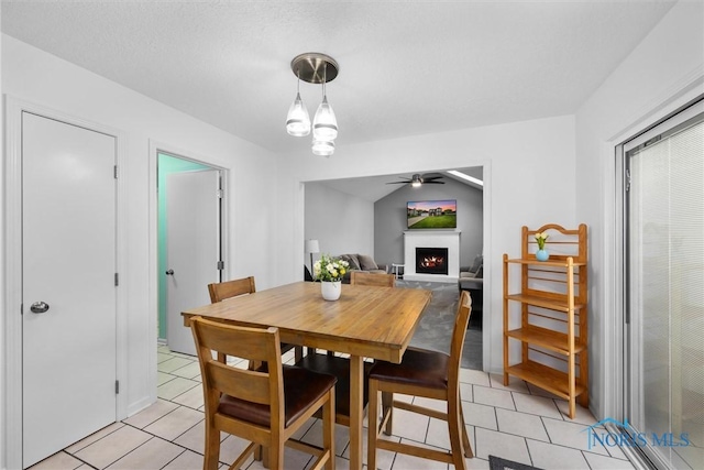 117 Freedom Ln, Waterville, OH 43566 - dining area with ceiling fan, a warm lit fireplace, and light tile patterned floors