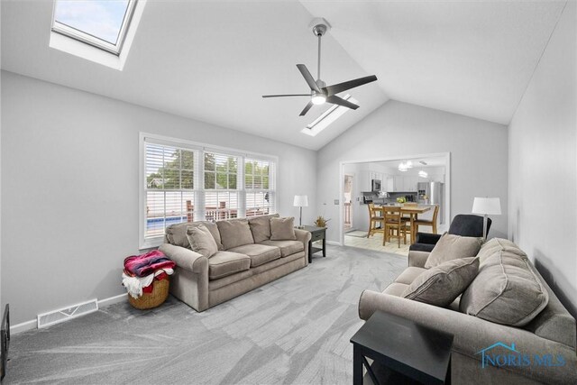 117 Freedom Ln, Waterville, OH 43566 - carpeted living room with a skylight, lofted ceiling, a ceiling fan, and baseboards