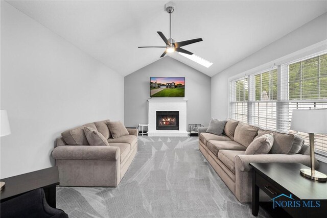 117 Freedom Ln, Waterville, OH 43566 - living area featuring ceiling fan, light carpet, a lit fireplace, and lofted ceiling
