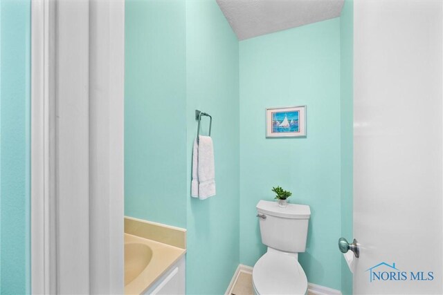 117 Freedom Ln, Waterville, OH 43566 - bathroom featuring toilet, baseboards, and vanity