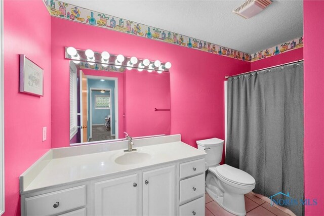 117 Freedom Ln, Waterville, OH 43566 - full bathroom with toilet, vanity, a textured ceiling, tile patterned flooring, and a shower with curtain