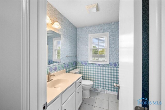117 Freedom Ln, Waterville, OH 43566 - half bath with wallpapered walls, toilet, vanity, and tile patterned floors
