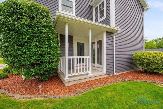 117 Freedom Ln, Waterville, OH 43566 - view of exterior entry featuring covered porch and a lawn
