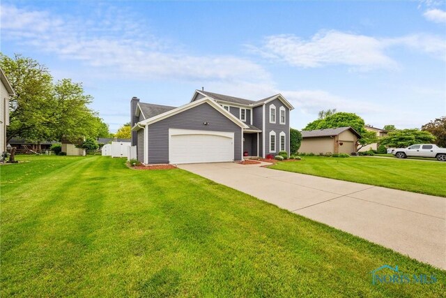 117 Freedom Ln, Waterville, OH 43566 - view of front of house featuring a garage, a front yard, driveway, and a chimney