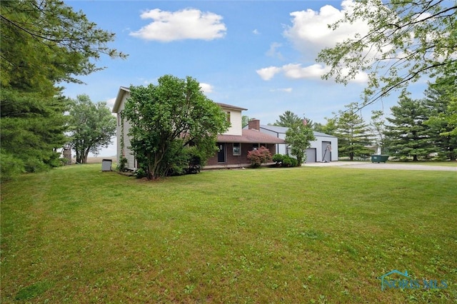 13914 Devils Hole Rd, Bowling Green, OH 43402 - view of front of property featuring driveway, a garage, a front yard, and an outbuilding