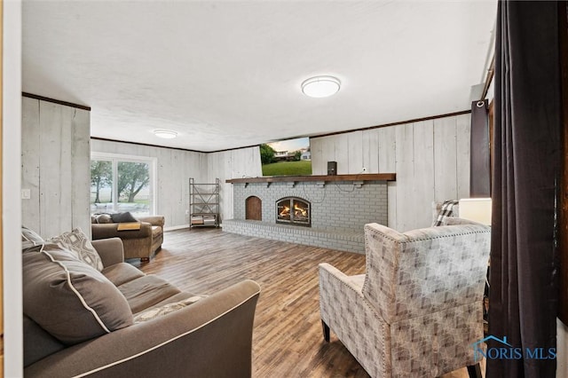 13914 Devils Hole Rd, Bowling Green, OH 43402 - living room featuring a brick fireplace, wood finished floors, and wooden walls