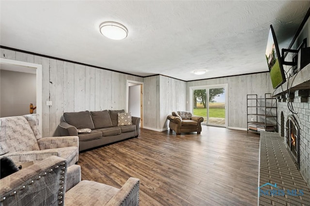13914 Devils Hole Rd, Bowling Green, OH 43402 - living room featuring a fireplace, crown molding, wood finished floors, baseboards, and wooden walls