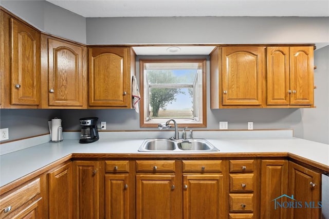 13914 Devils Hole Rd, Bowling Green, OH 43402 - kitchen with a sink, light countertops, and brown cabinets