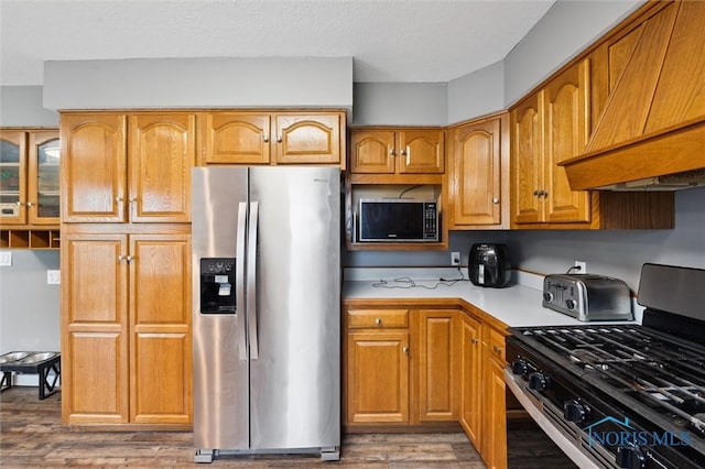 13914 Devils Hole Rd, Bowling Green, OH 43402 - kitchen with appliances with stainless steel finishes, custom exhaust hood, light countertops, wood finished floors, and brown cabinets