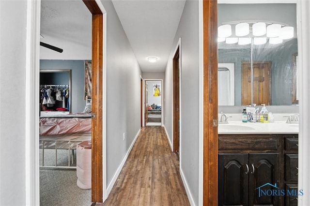 13914 Devils Hole Rd, Bowling Green, OH 43402 - hallway with a sink, wood finished floors, and baseboards