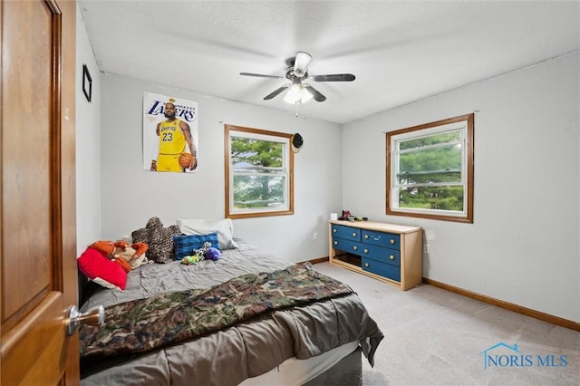 13914 Devils Hole Rd, Bowling Green, OH 43402 - bedroom with light colored carpet, baseboards, and a ceiling fan