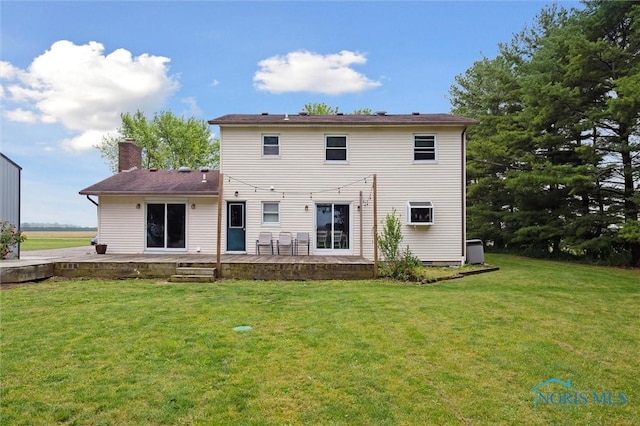 13914 Devils Hole Rd, Bowling Green, OH 43402 - back of house featuring a lawn, a chimney, a patio area, and central AC