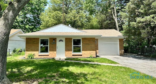 3530 Helene Ct, Toledo, OH 43623 - view of front of house featuring brick siding, an attached garage, driveway, a front lawn, and a shingled roof