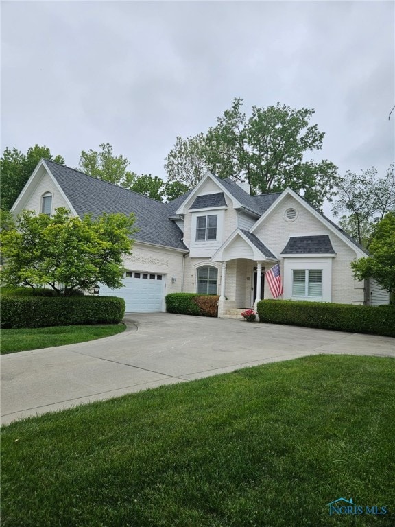 3236 Deep Water Ln, Maumee, OH 43537 - view of front facade with driveway, a front yard, an attached garage, and a shingled roof