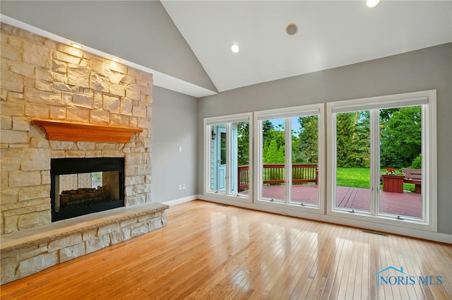 3236 Deep Water Ln, Maumee, OH 43537 - unfurnished living room featuring wood-type flooring, a stone fireplace, and high vaulted ceiling