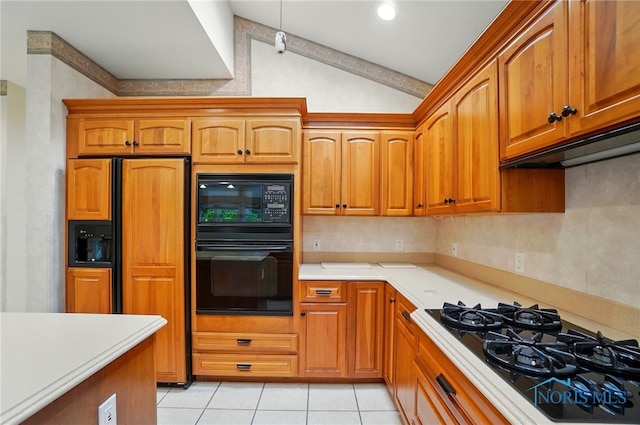 3236 Deep Water Ln, Maumee, OH 43537 - kitchen with black appliances, lofted ceiling, light countertops, light tile patterned floors, and brown cabinets