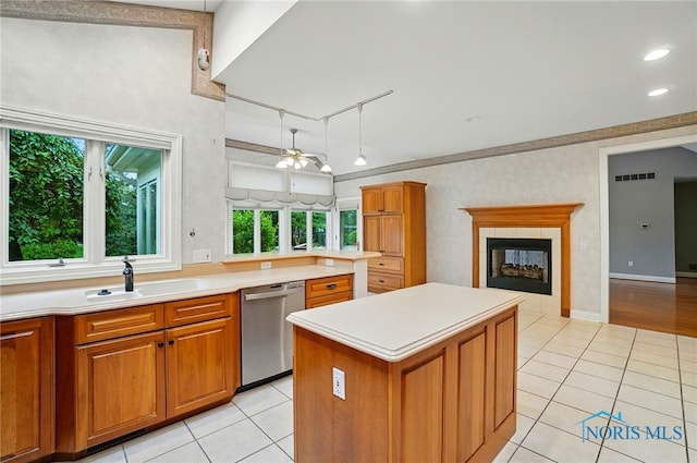 3236 Deep Water Ln, Maumee, OH 43537 - kitchen with stainless steel dishwasher, light tile patterned floors, a ceiling fan, and brown cabinetry