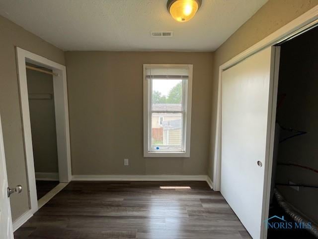 821 Vinton St, Toledo, OH 43609 - unfurnished bedroom with wood finished floors, baseboards, and a closet