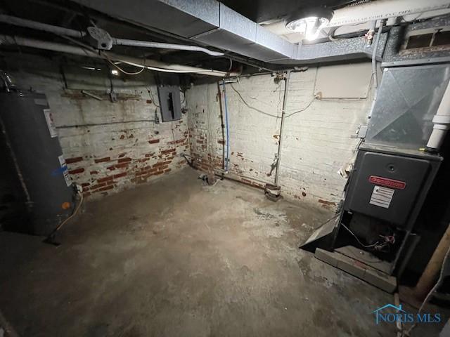 821 Vinton St, Toledo, OH 43609 - unfinished below grade area featuring electric panel, water heater, and heating unit