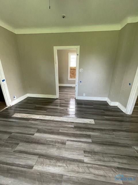 821 Vinton St, Toledo, OH 43609 - spare room featuring baseboards and dark wood finished floors