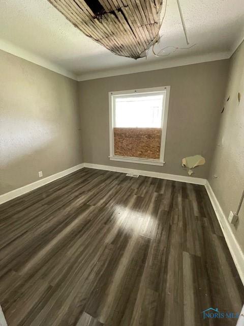 821 Vinton St, Toledo, OH 43609 - unfurnished room featuring baseboards and dark wood-style flooring