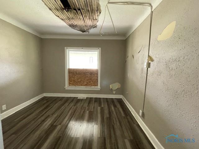 821 Vinton St, Toledo, OH 43609 - unfurnished room featuring dark wood-style flooring, baseboards, and crown molding