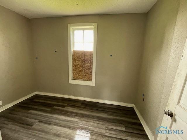 821 Vinton St, Toledo, OH 43609 - spare room with wood finished floors, baseboards, and a textured ceiling
