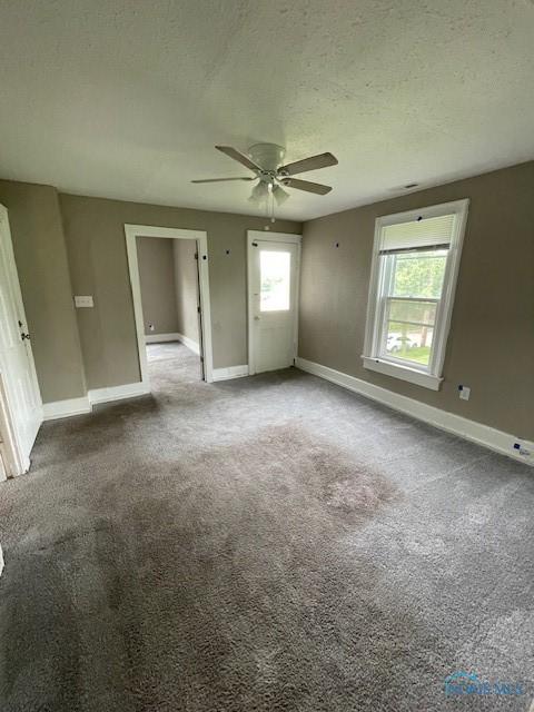 821 Vinton St, Toledo, OH 43609 - unfurnished room with a ceiling fan, baseboards, a textured ceiling, and carpet floors