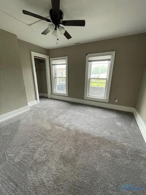 821 Vinton St, Toledo, OH 43609 - unfurnished bedroom featuring multiple windows, baseboards, and light carpet