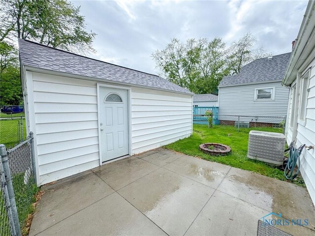4635 Vermaas Ave, Toledo, OH 43612 - view of patio featuring central air condition unit and an outdoor structure