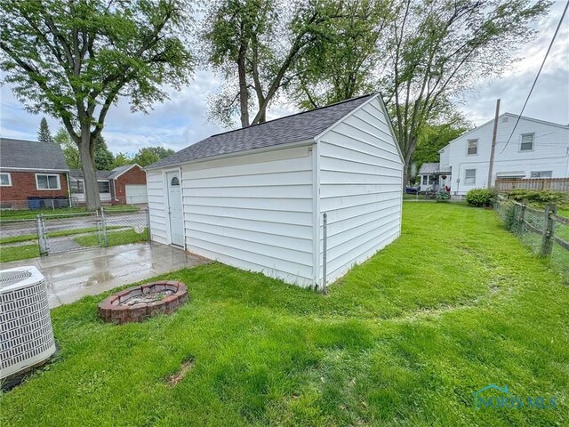 4635 Vermaas Ave, Toledo, OH 43612 - view of outbuilding with central AC unit and an outdoor fire pit
